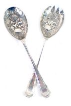 A pair of Queen Elizabeth II silver salad servers, each with berry punched bowl, of fruits, with imp