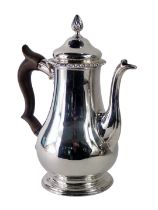 A George III silver coffee pot, with a fluted knop and border, bearing lion and crest, on a turned w