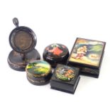 A group of Russian black lacquer painted trinket boxes, comprising two oval examples, each decorated