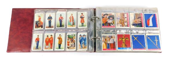 A cigarette card album, containing contents of Wills Royalty cigarette cards, Players Army and Naval