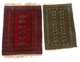 An Afghan rug, with a design of medallions on a green ground, and a red ground belouch type rug, 119