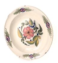 A French Faience charger, in stoneware with glazed and raised border with decoration of pink flowers