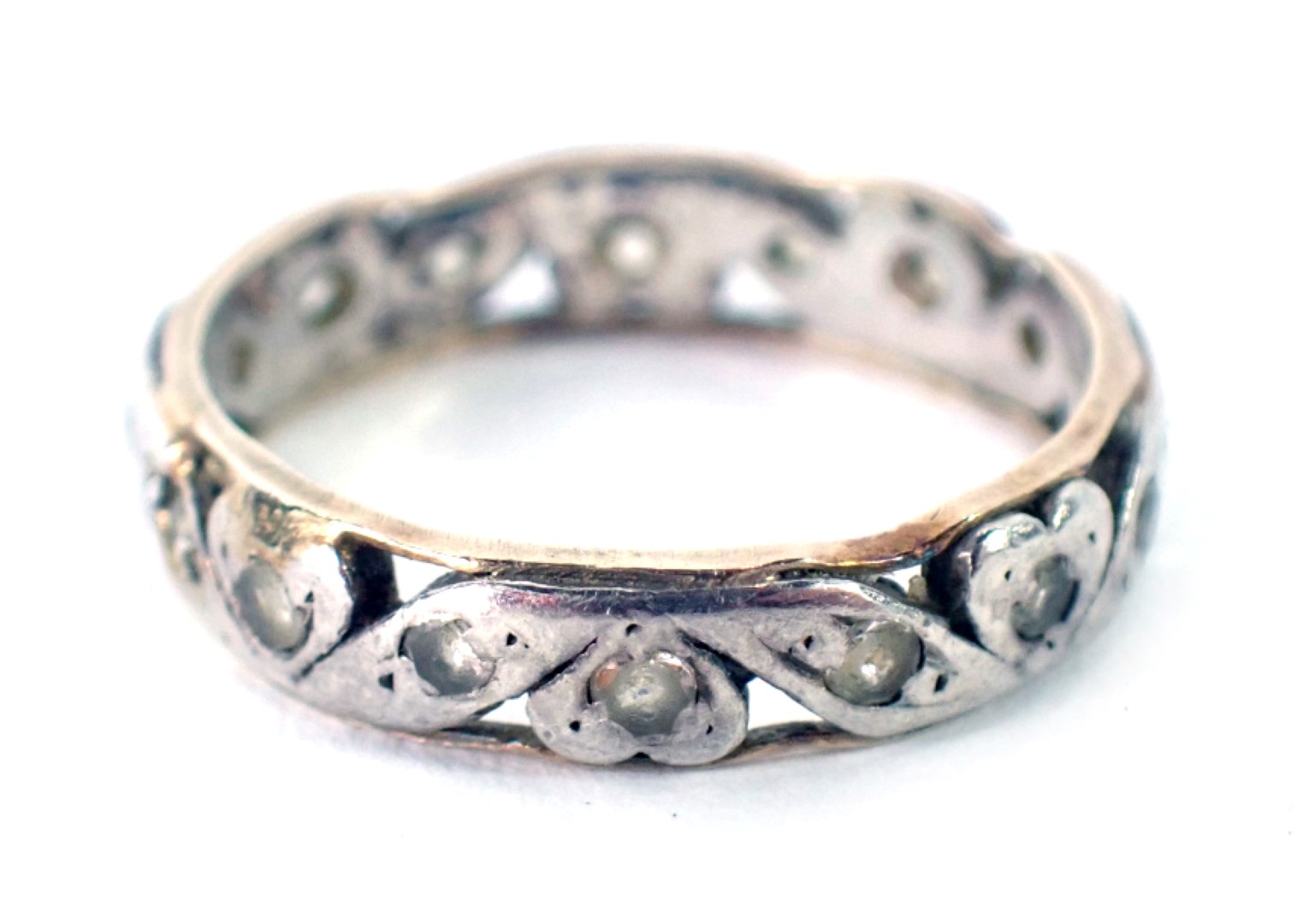 An eternity ring, with two panelled yellow metal outer border, and white gold centre, set with white