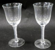 A pair of 20thC air twist stem wine glasses, 16cm high.