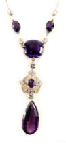 An Edwardian amethyst and diamond necklace, with central cushion set amethyst 14mm x 12mm, claw set,