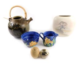 A group of studio pottery, comprising a painted blue bowl stamped Idonia, and matching milk jug, egg