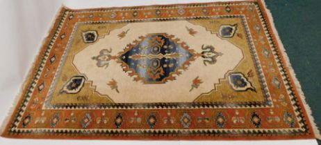 A Kabir wool rug, with red and gold ground, 200cm x 295cm.