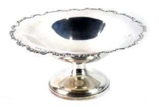 A George V silver fruit bowl, with a fluted scroll border, on circular foot, maker THE, Birmingham 1