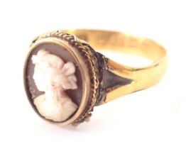 A 22ct gold cameo dress ring, a central raised and carved cameo depicting a maiden looking dexter, w