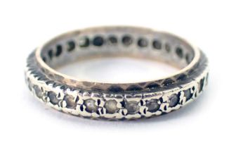 A 9ct gold and silver eternity ring, set with tiny diamonds on bicolour design, ring size K½, 2.2g a