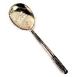 An eastern white metal serving spoon, with scroll design handle, white metal stamped SS, with weight