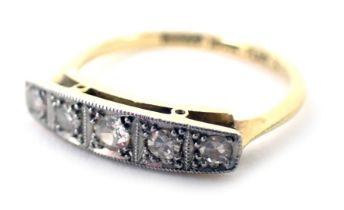 A diamond set panel ring, the panel set with five round brilliant cut diamonds, each in claw setting