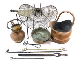 A group of copper and brass wares, comprising a peacock fan fire guard, trivet, ram head poker, copp