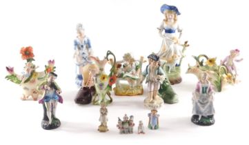 A quantity of German porcelain figures, to include two with flower encrusted decoration, boots, etc.