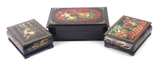 Three Russian black lacquer trinket boxes, decorated with maiden and warrior, figure on horseback, a