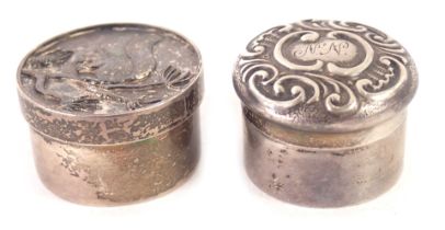 Two white metal pill boxes, comprising a Queen Elizabeth II silver pill box, with squirrel and acorn
