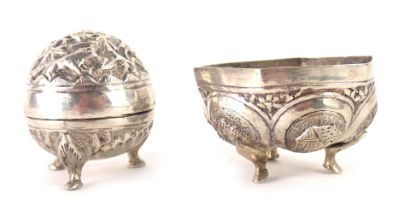 Two items of Burmese white metal, comprising a swatch pepper pot on tripod claw feet, 4cm high, unma
