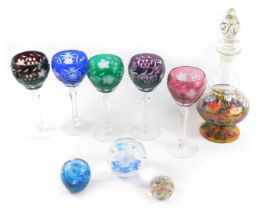 A set of five coloured glass hock glasses, each with pressed floral design with grapes and flowers,