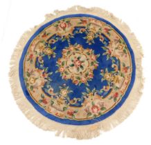 A Chinese cut wool circular floral rug, on blue ground, 148cm diameter.