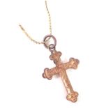 A crucifix pendant and chain, the crucifix of floral design, yellow metal stamped 9ct, on fancy link
