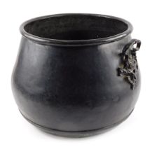 A hammered metal cauldron, coal bucket, with floral handles, 31cm high, 32cm diameter.