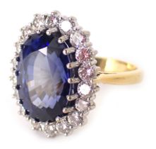 An 18ct gold sapphire and diamond cluster ring, the central sapphire 13.6mm x 9.6mm x 6.8mm,