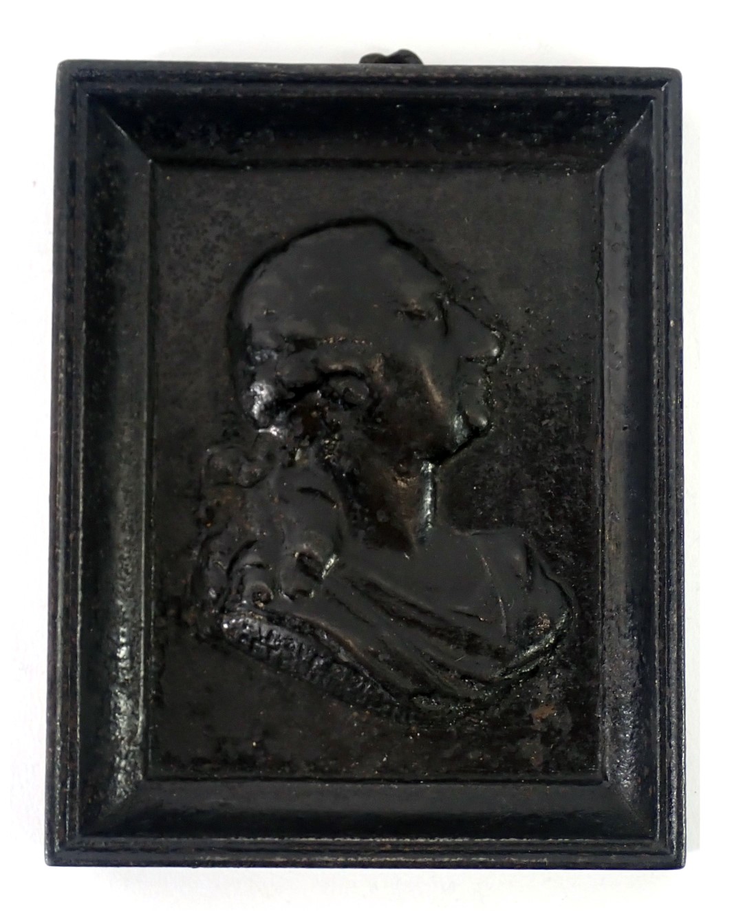 A 19thC cast iron portrait plaque of Mozart, in a rectangular moulded frame, bearing signature, 12.5