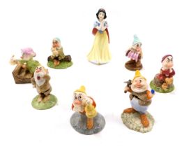 A Royal Doulton Snow White and The Seven Dwarfs Disney showcase set.