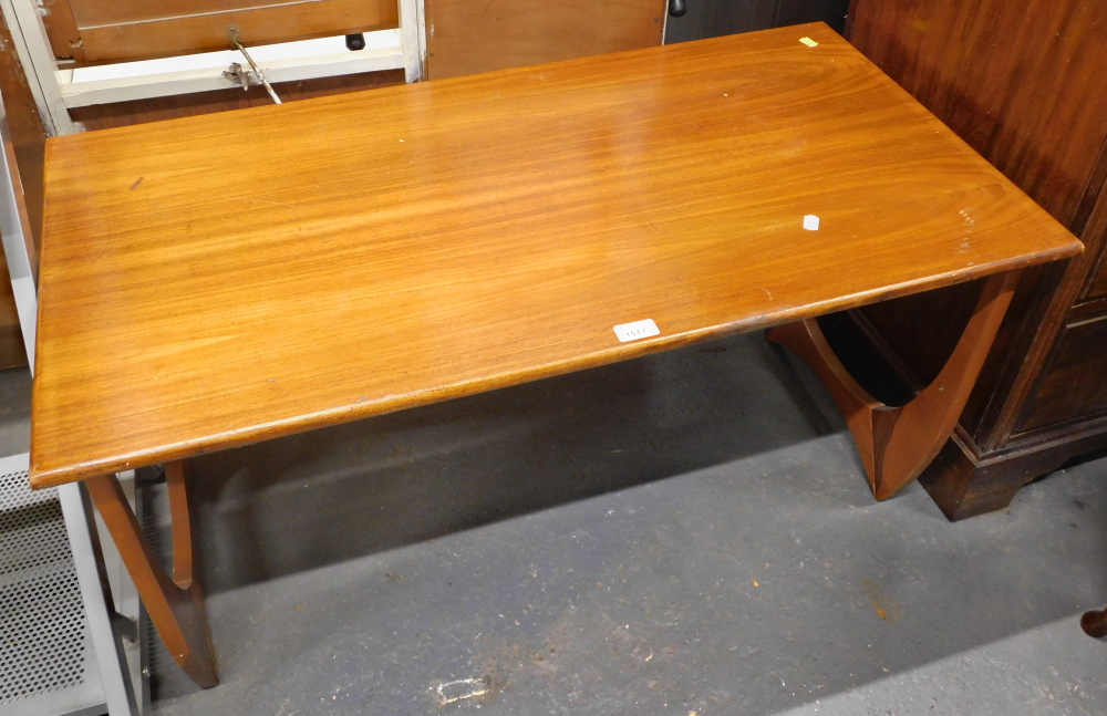 A teak rectangular coffee table, with arched and shaped supports.