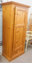 A pine single wardrobe, with single cupboard and drawer base, on block foot, 192cm high, 78cm wide,