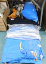 A material suitcase, canopy throw, tent, various poles, and sleeve. (a quantity)