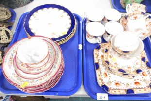 Two Coalport cabinet plates, decorated with flowers, two further Coalport cabinet plates on a blue g