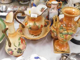 Staffordshire pottery with fruits, comprising jug, bowl, ewer, two handled vase and lidded jar. (5)