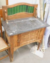 A Victorian black marble topped wash stand, with green tiled back on tapered legs.