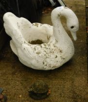 A reconstituted stone and painted swan garden planter, 51cm high, and stone turtle ornament.