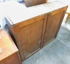 A stained pine two door cupboard.