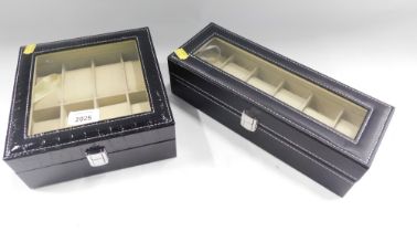 Two black leatherette watch cases.