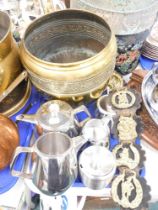 A hammered brass planter, horse brasses, and a stainless steel part service. (1 tray)