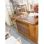 A teak bookcase, two pine beech effect kitchen stools, cabriole legged coffee table, reproduction co