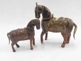 Two Oriental hardwood and brass mounted horse ornaments. (2)