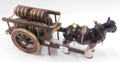 A ceramic shire horse pulling cart.