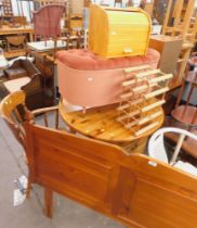 A pine double headboard, circular kitchen table, armchair, Lloyd Loom style basket, wine rack, three