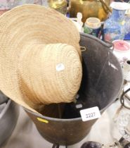 A copper fire bucket and a straw hat.