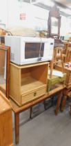 A Daewoo microwave, mahogany dressing table mirror, brush style bedside cabinet, pine table, a stool