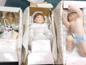 Three Ashton Drake ceramic headed dolls, comprising Snug As A Bug In A Rug, My Little Ballerina, and