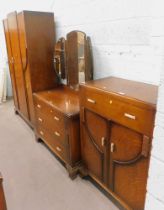 An oak three piece bedroom suite, comprising wardrobe, dressing table and tallboy, in the Art Deco s