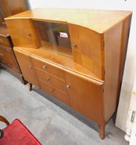 A teak sideboard, with two cupboard section and slide door above arrangement of three drawers and tw