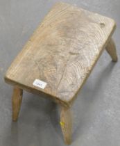 A 19thC rectangular elm milking stool.