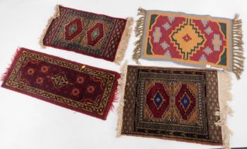 Four Middle Eastern prayer rugs, each with medallions.