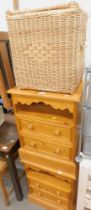 A pair of pine bedside cabinets, and a wicker towel basket. (3)